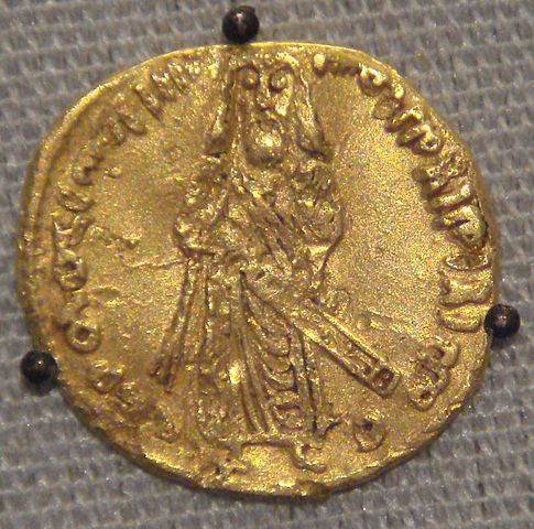 695 CE Umayyad dinar coin at the British Museum. (Wikimedia: "Umayyad Caliph 'Abd al-Malik: 'Caliphal Image solidus' or Standing Caliph solidus struck from 74-77 AH. Based on Byzantine numismatic traditions.")